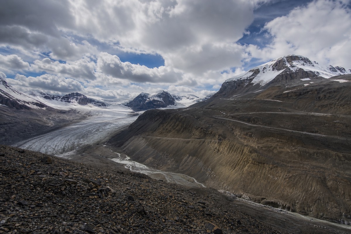 The Columbia Icefield Glacier Discovery Centre with Ice Explorer vehicles and the Athabasca Glacier beyond